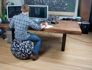 Man at computer desk on yoga ball