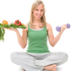 woman with veggies and small dumbbell 